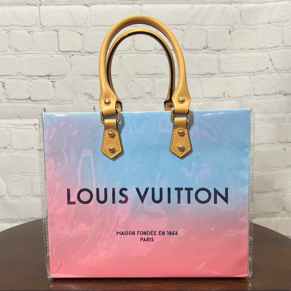 Authentic Louis Vuitton Ombré Paper bag wrapped in Vinyl making it a useful bag